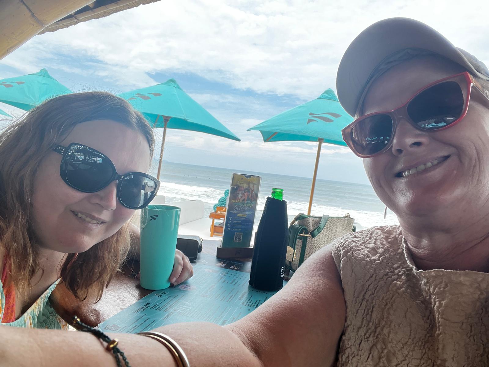 Guests enjoying a beachfront table at a Bali beach club
