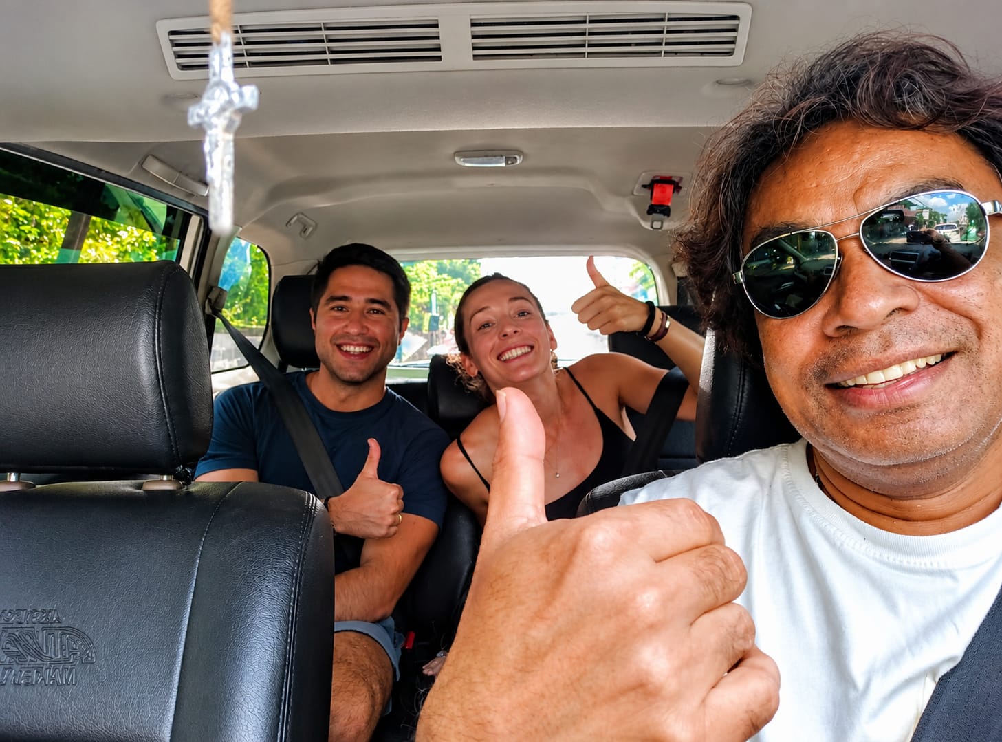 Happy guests traveling in an Islandora vehicle