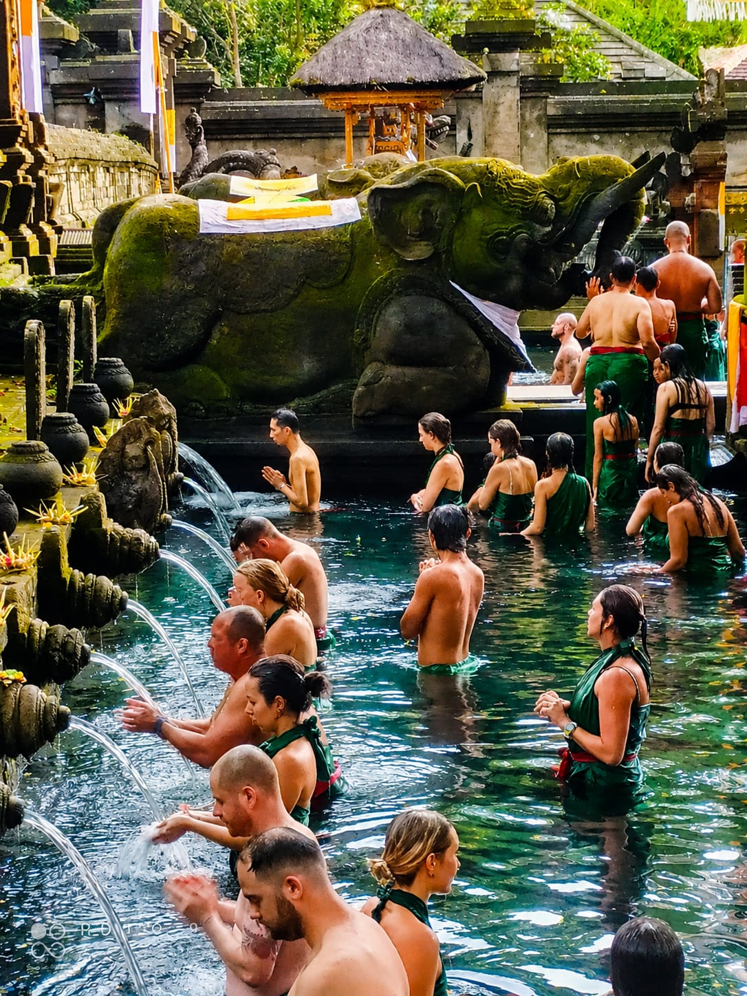 Guests taking part in a traditional holy water ritual at a Balinese temple